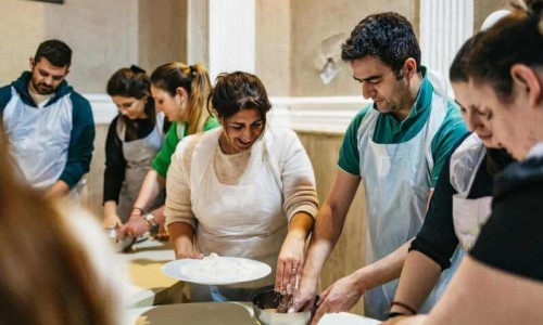 Tourists enjoying cooking in naples, Italy.